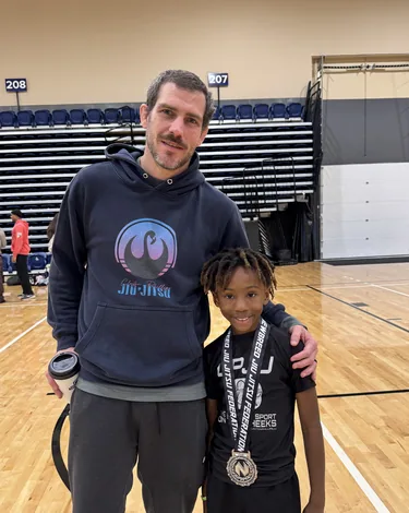 Coach Clayton Phillips with one of his athletes after a competition